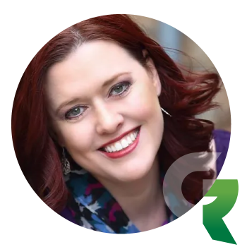 A smiling woman with shoulder-length auburn hair.