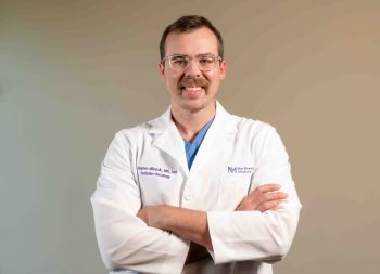 Dr. Stephen Mihalcik, Radiation Oncologist at Northwestern Medicine, wearing a white lab coat.